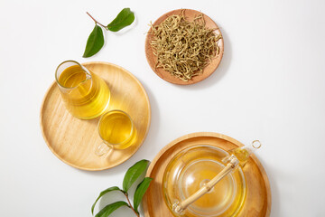 Canvas Print - Fresh ginger and cup of tea with green tea on white background. Natural herbal healthy drinks concept. Top view.