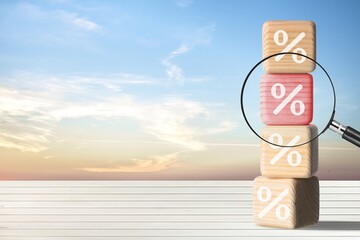 Sticker - Choosing the best interest rate of a financial and mortgage loan. Wooden cube blocks on the desk