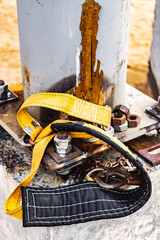 Wall Mural - The safety belt of a welder or assembler lies on a concrete foundation at a construction site. Protection of a person working at height. Safety engineering.