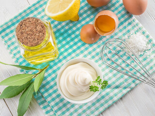 Wall Mural - Homemade mayonnaise with ingredients and herbs. Top view.