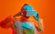 Leinwandbild Motiv Serious woman experiencing virtual reality in VR goggles