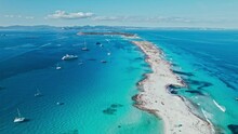 White Sand Platja De Ses Illetes Beach On A Narrow Strip Of Land On Formentera. Blue Famous Beach With People Relaxing On Vacation In The Mediterranean Sea With Luxury Vessels And Boats.