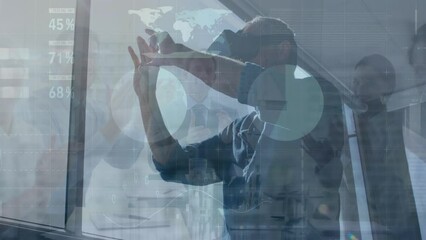Poster - Animation of graphs and data over caucasian man in vr headset and businesspeople clapping hands