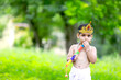 happy Janmashtami Greeting Card showing Little Indian boy posing as Shri krishna or kanha/kanhaiya with Dahi Handi picture and colourful flowers