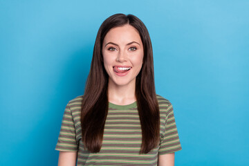 Poster - Photo of nice young brunette lady lick wear green t-shirt isolated on blue color background