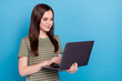 Leinwandbild Motiv Photo of ceo young brunette lady type laptop wear striped t-shirt isolated on blue color background