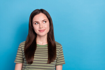 Poster - Photo of funny young brunette lady look up wear green t-shirt isolated on blue color background