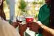 © Seventyfour - Close up of friends toasting with wine glasses in celebration during outdoor party in Summer