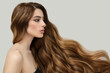 © Alena - Beautiful model girl with long wavy and shiny hair . Brunette woman with curly hairstyle