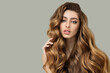 © Alena - Portrait of a beautiful brunette with long wavy hair. Show off your curls. copyright