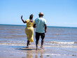Mature couple wading in sea