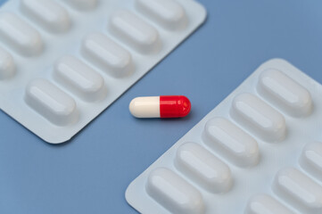 Vitamins tablets supplements on Blue background