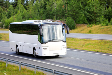 Wall Mural - white coach bus traveling on motorway. no people, no logos.