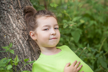 young beautiful preschool girl in a summer park