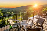 Fototapeta Miasta - Beautiful dawn sunshine breaking over hills with wooden balcony