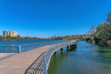 Wall Mural - Boardwalk with concrete pavement and metal railings over Colorado River at Austin, Texas