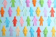 Many different paper human figures on light blue background, flat lay. Diversity and inclusion concept