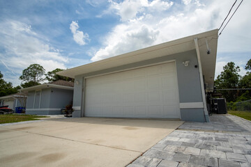 Wall Mural - Wide garage double door and concrete driveway of new modern american house