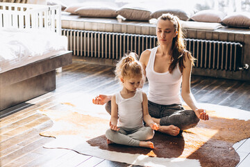 Wall Mural - Mother and daughter yoga at home