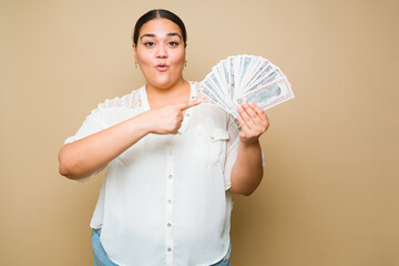 Surprised plus size woman earning a lot of money