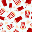 Seamless pattern with striped bucket of popcorn, popcorn kernels and red cup with soda. Cinema junk food.