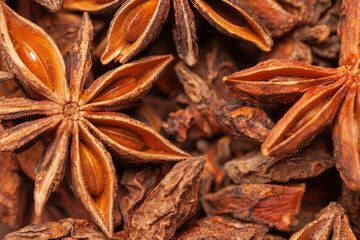 Wall Mural - A group of star anises close up background. Dried star anise spice fruits top view