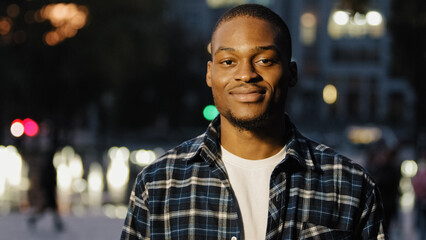 Portrait in night city evening outdoors african american friendly successful man guy in plaid shirt applauding hands congratulating expressing admiration clapping palms applause cheering concept