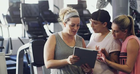 Poster - Talking female fitness group on a tablet browsing the web and social media at a gym. Women exercise group watching a video and talking together. Fitness class looking online after a training workout