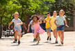 © JackF - Cheerful active children are racing along the city street