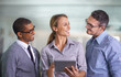 © Mapodile M./peopleimages.com - Happy, smiling and confident business woman with her team happy about a teamwork proposal collaboration. Corporate office workers with a tablet. Staff ready to work on a group job together