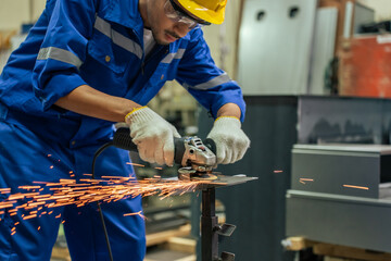 Wall Mural - Asian attractive man industrial worker working in manufacturing plant. 