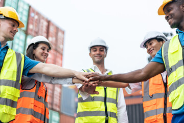 Group of man and woman worker put hand on each other in container port