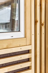 Wall Mural - Building wall and window decorated with stylish wooden slats made of thin light planks on house terrace extreme close view