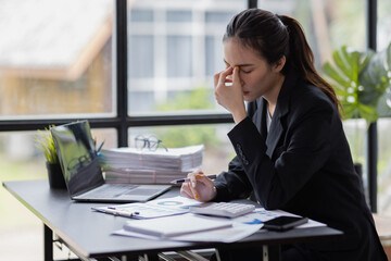 Stress Asian woman business people and work concept, a tired Asian businessman in workplace office desk.