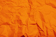 Leinwandbild Motiv Sheet of orange crumpled paper as background, closeup