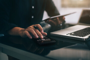 Wall Mural - Businessmen are calculating income-expenditure and analyzing real estate investment data at office, Accounting Financial and tax systems concept.