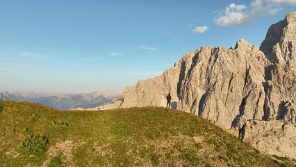 Wall Mural - View from above, stunning aerial view of a person enjoying the view of Monte Pelmo from the summit of Col de la Puina. Monte Pelmo, Dolomites, Italy.