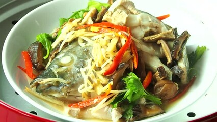 Wall Mural - Steaming tilapia fish with herbs in pot, Thai famous food.