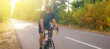 © Solid photos - Young sports man cycling with bicycle on the road in summer