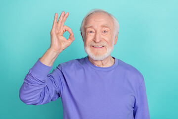 Wall Mural - Portrait of positive friendly person hand fingers demonstrate okey symbol isolated on emerald color background