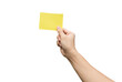 © Achira22 - Hand holding yellow paper isolated on white with clipping path.