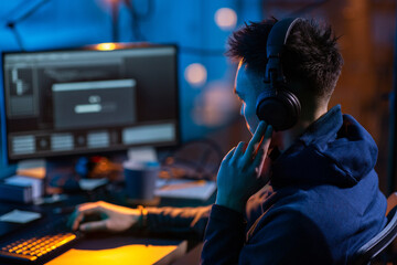 Poster - cybercrime, hacking and technology concept - close up of male hacker in dark room writing code or using computer virus program for cyber attack