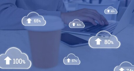 Poster - Animation of clouds with changing numbers over caucasian man working over laptop by coffee on desk