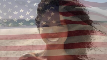 Wall Mural - Animation of flag of america over portrait of smiling african american young woman at beach