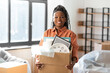© Syda Productions - moving, people and real estate concept - happy smiling woman holding box at new home
