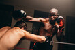 © Jacob Lund - Two male fighters having a match in a boxing ring
