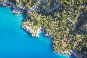 Fototapete - Beautiful aerial view of sea lagoon with blue water, Mediterranean, Turkey.  Small rocky island among sea.  The bottom of the sea from above.