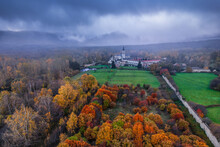 Amazing Landscape Of Mountainous Town Surrounded By Colorful Autumn Forest On Cloudy Day