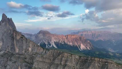 Wall Mural - View from above, stunning aerial view of the mountain range of Seceda during a beautiful sunset. The Seceda with its 2.500 meters is the highest vantage point in Val Gardena, Dolomites, Italy