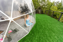 Woman Doing Yoga In Glamping Dome Tent